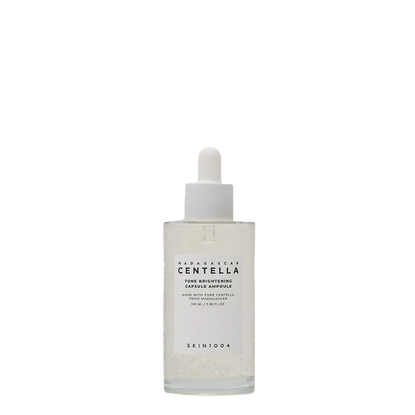 Botella de vidrio de 100 ml con gotero de la ampolla coreana Madagascar Centella Tone Brightening Capsule Ampoule de la marca Skin1004, sérum iluminador y despigmentante con microcápsulas aclarantes.